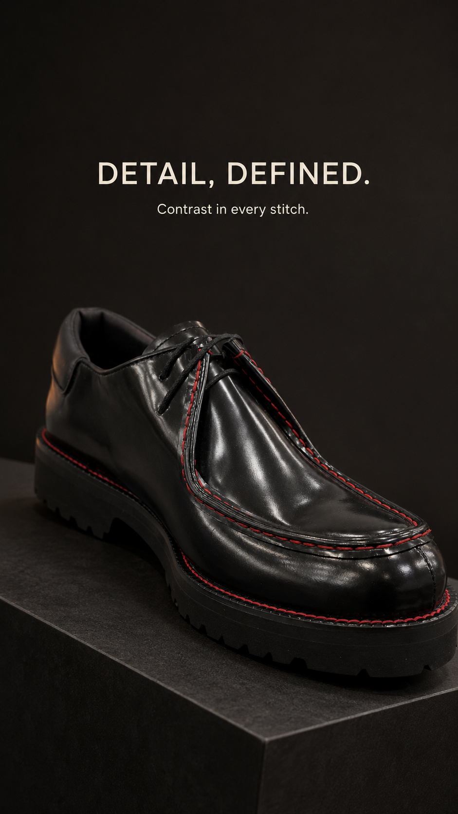 Black lace-up shoe with red contrast stitching