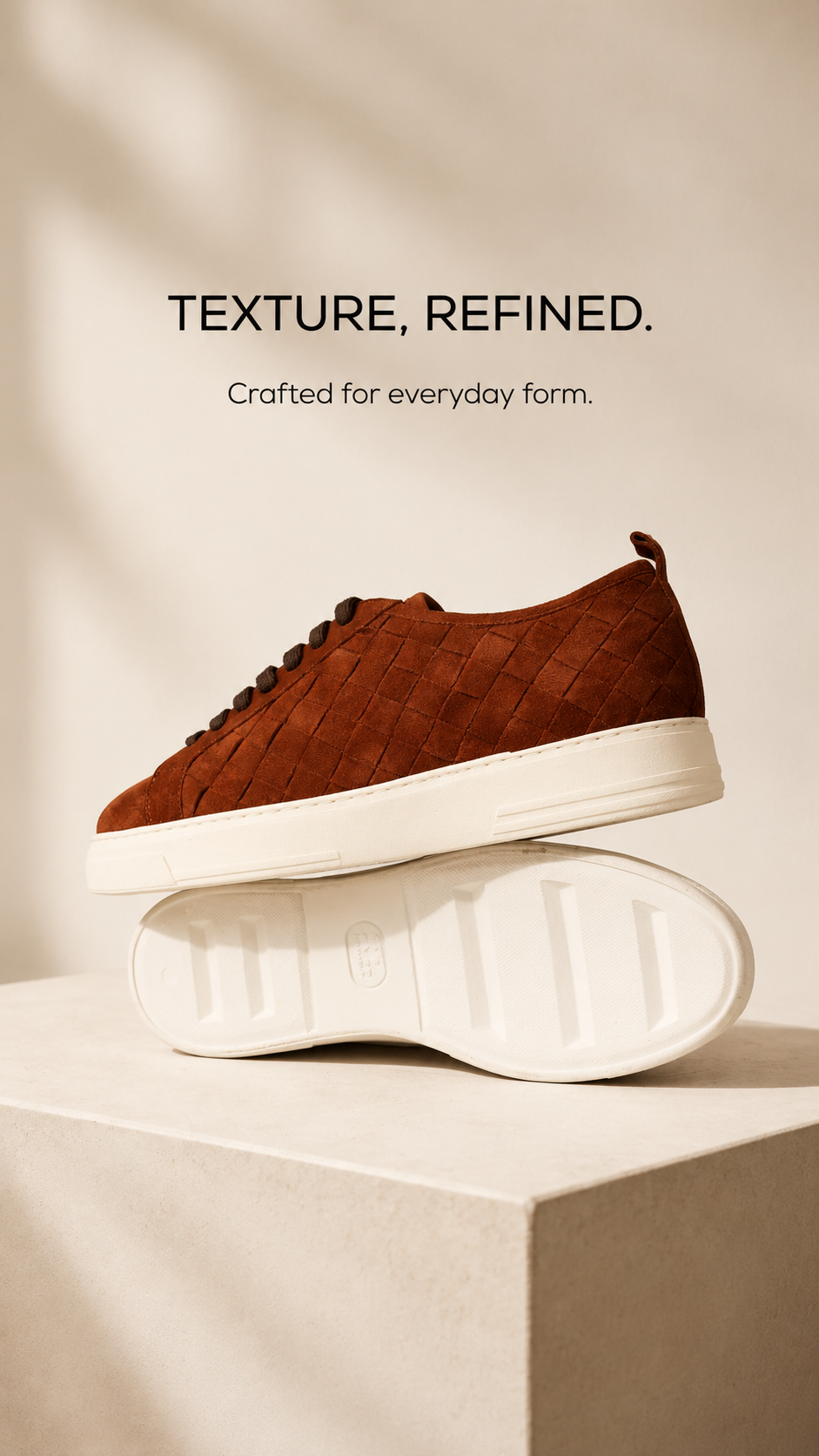 Brown textured high-top sneaker on a cream plinth