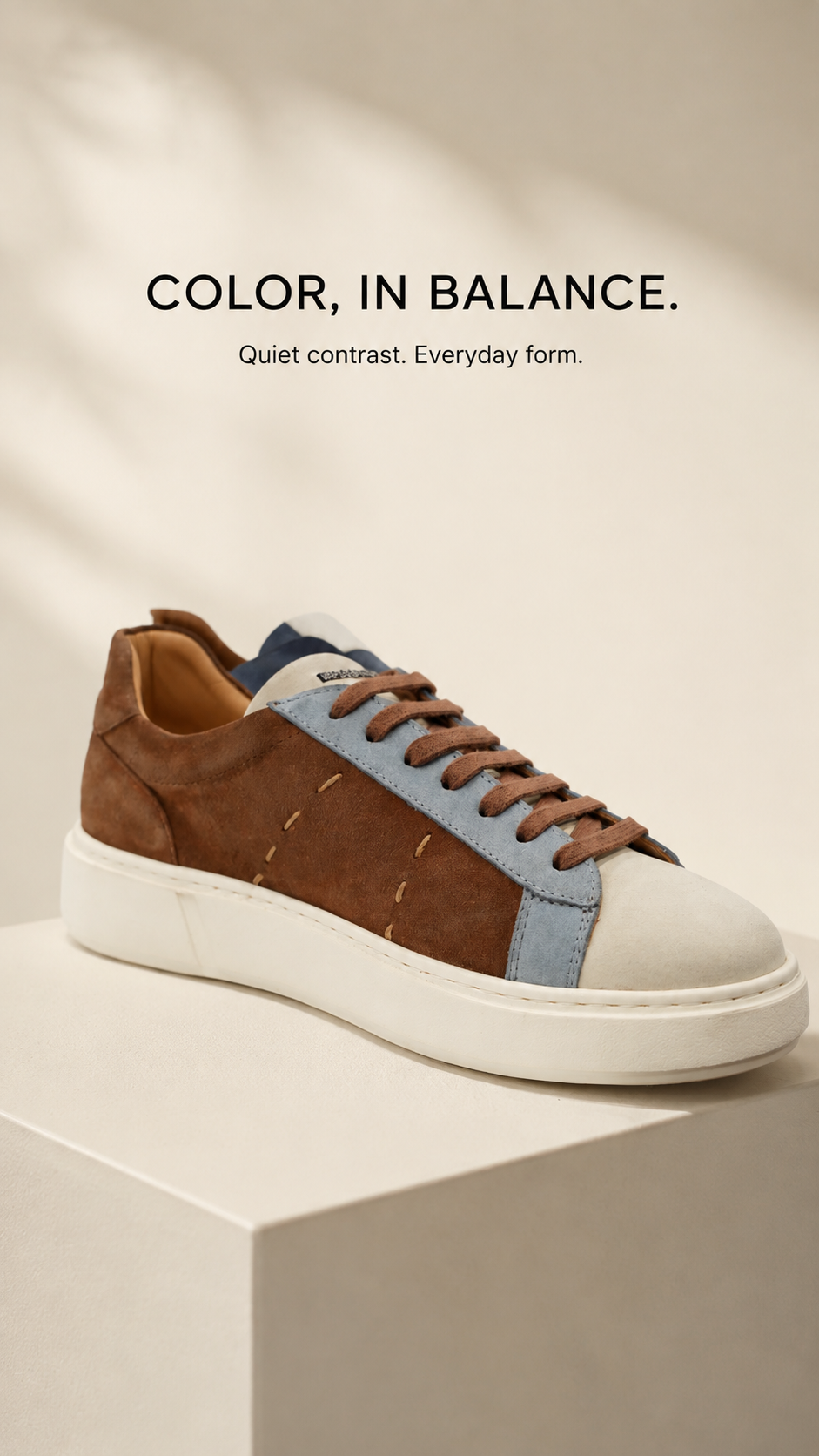 Brown and blue panelled sneaker with a cream sole